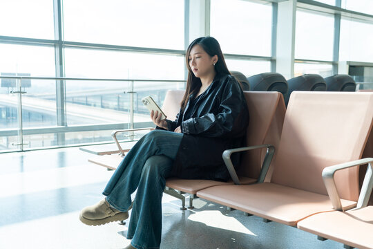 Woman using smartphone at airport