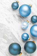 Blue christmas bauble decoration on marble table background, top view