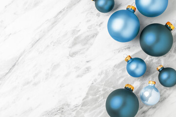 Christmas balls decoration on white marble table with copy space