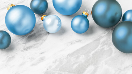 Modern Christmas decoration with baubles on marble table background, copy space