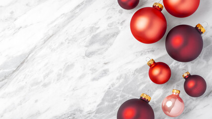 Red christmas baubles on marble table, holiday concept, copy space