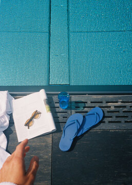 Relaxing by the Pool With Sunglasses, a Drink, and Flip-Flops
