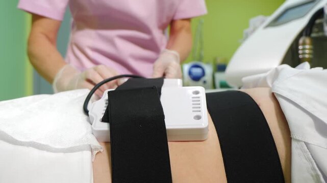 Lipo laser equipment on female body in medicine salon or modern beauty clinic. Body care. Fast fat burning. wellness center with weight loss procedures. 4 k video