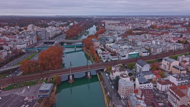 Drone fly at railway bridge over Marne River canal on the border of Alfortville and Saint-Maurice, Paris, France