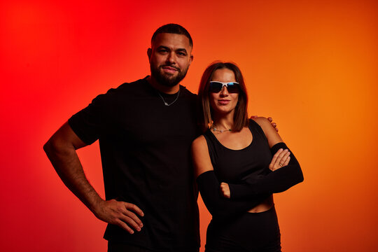 Friends posing together against a colorful background at a studi