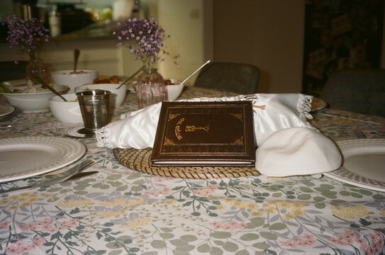 Shabbat Table Setting With Kiddush Cup, Kippah, and Challah Cover