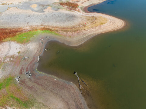Abstract patterns of land and vegetation around a drying reservoir