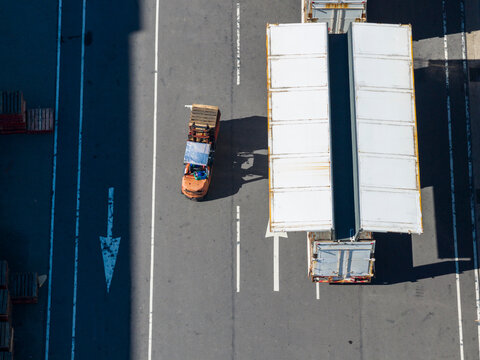 Aerial View of Forklift and Gull-Wing Trucks Loading Cargo