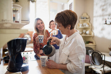 Friends enjoying coffee together in a cozy kitchen setting