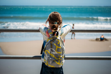 Child enjoying the view of the beach and ocean