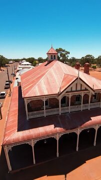 Historic building with ornate veranda and red corrugated iron roof