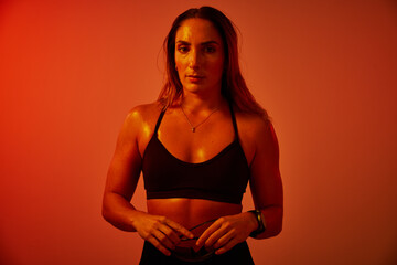 Strong woman showcasing fitness in warm lighting