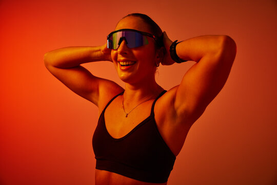 Focused athlete enjoying a moment of triumph with stylish eyewea