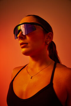 Stylish athlete poses confidently in vibrant light