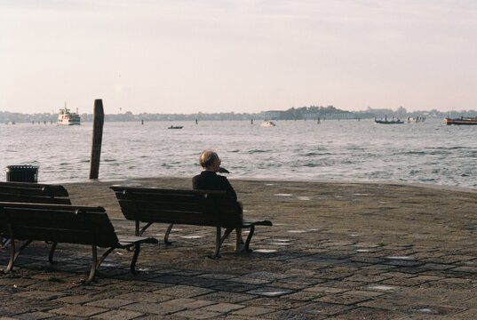 Person on bench overlooking water in Venice
