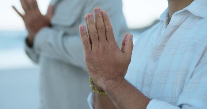 Meditation, prayer hands and peace with people at beach for mindfulness, spiritual balance and health. Chakra, namaste pose and yoga routine with friends outdoor for holistic wellness and fitness