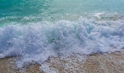 Turquoise sea water wave motion. Summer beach. Calm sea. Beauty sky and waves on beach. Beautiful foamy shoreline. Sea background. Blue ocean. Sandy ocean beach. Sea waves.
