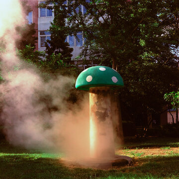 An outdoor vent is decorated to look like a giant green mushroom
