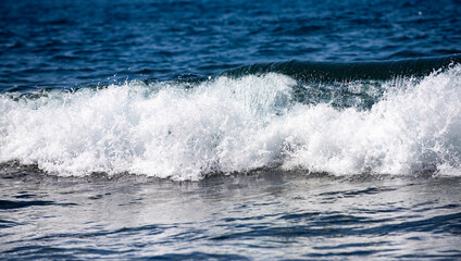 Naklejka premium Sea wave drop. Sea waves in motion. Foam forms on ocean wave. Wave sparkle. Ocean breeze with waves. Waves roll in marine.