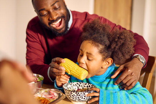 Father gives corn to her daughter