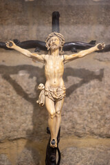 Crucifixion sculpture on a stone background.. Orense Cathedral, Spain