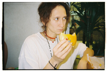 Woman enjoying a burger in a casual dining setting