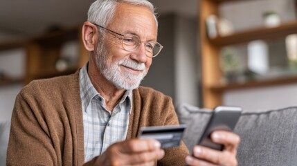 Senior man uses smartphone and credit card at home to shop online during the day