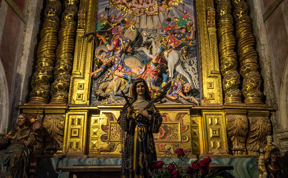 Intricate altar with a statue and colorful artwork.. Orense Cathedral, Spain
