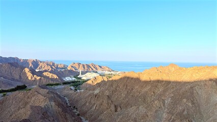 Desert Landscape Panorama, Scenic View Of Arid Valleys, Vast Mountainous Desert With Flowing River, Wide Desert Ridges With Lush Green Valleys And Winding Streams Stretching Beyond