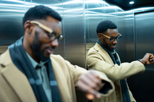 Gentleman in elevator checking time