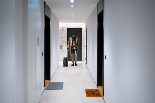 Traveler entering hotel hallway