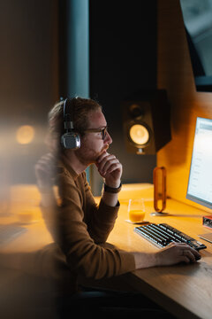 Focused man working at a computer in a modern office space
