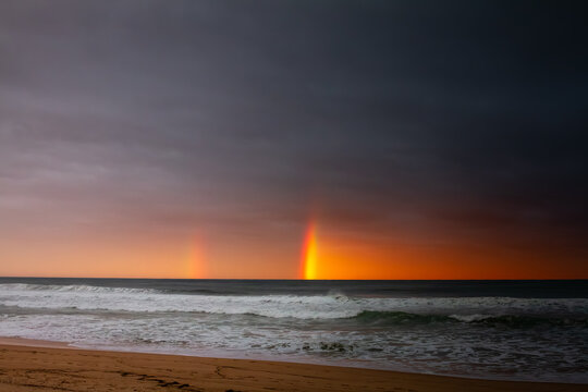Double Rainbow in a Cloudy sunset