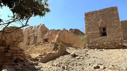Ancient Fortress Remains, Deserted Rocky Fortress Ruins, Solitary Tower And Dilapidated Walls Under Bright Sky, Weathered Stone Fortress Overlooking Arid Land With Sharp Silhouettes Against Blue Sky