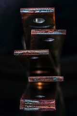 Oxidized coated copper busbars, non-ferrous metal products for the power industry, close-up view with industrial lighting