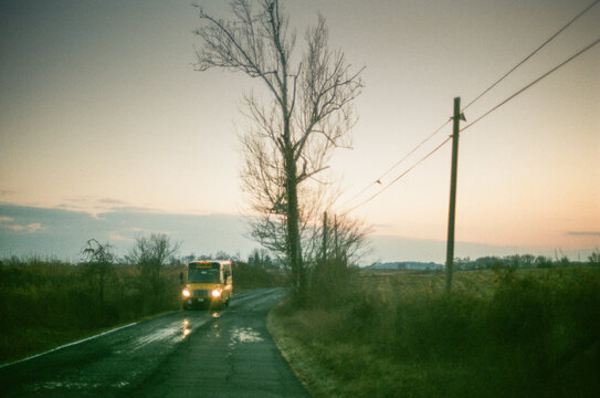 late day school bus on country road