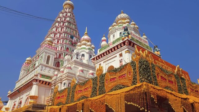 During the annual Paush Shukla Paksha Trayodashi Yatra festival at Shri Khandoba Temple, Pal, vibrant yellow and green garlands adorn the structure, creating a mesmerizing divine aura.