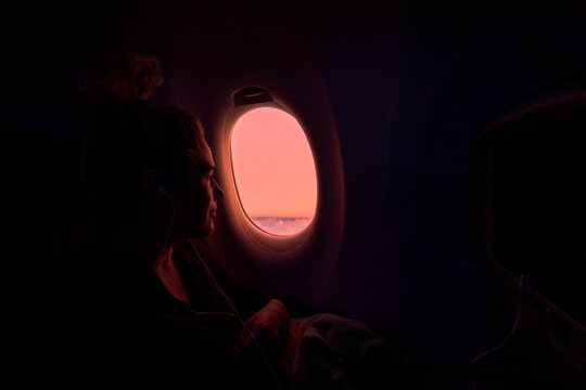 cinematic Traveler Looking Out Airplane Window