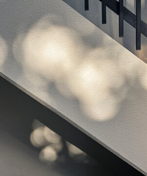 Geometric Shadows on Concrete Wall Under Sunlight