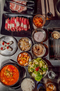 Assorted Ingredients for Korean Barbecue on Table