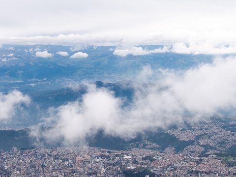 title: Aerial View of Quito City Through the Clouds