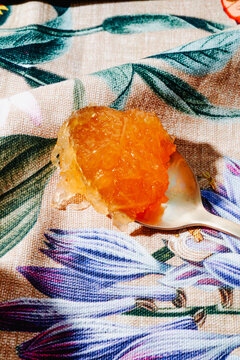 a spoonful of Spanish cabello de angel on a floral fabric