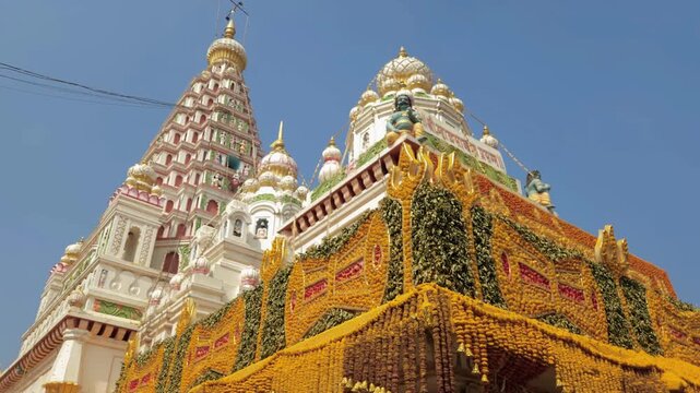 The Shri Khandoba Temple, located in Pal, Maharashtra, is an ancient Hindu temple dedicated to hosts an annual "Pal Yatra" festival celebrating his marriage, adorned with vibrant yellow green garland.