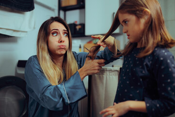 Clumsy Mother Cutting the Hair of her Daughter. Mom styling her kids hair at home making mistakes
