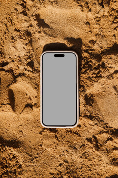 Smartphone Mockup with White Screen on Sand