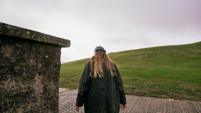 Woman walking near a cemetery