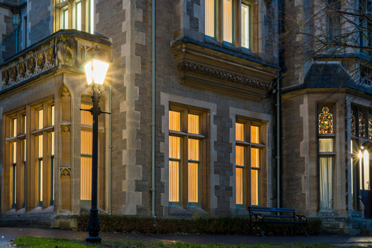 A Victorian office building and street light, with glowing windows