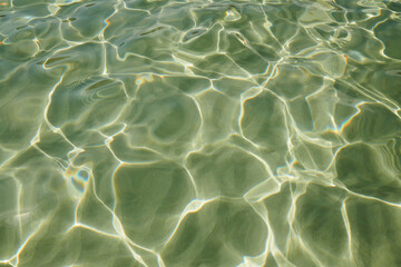 Clear water reflections create mesmerizing patterns under sunlight