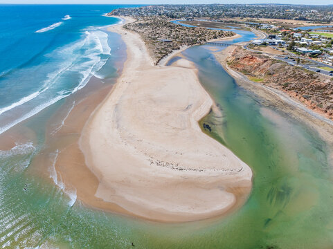 Coastal river winding around a large sand bar 
