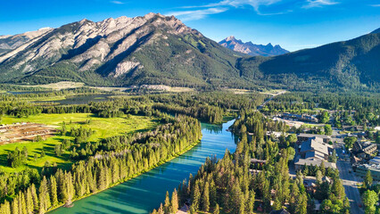 Panoramic aerial shot of Banff National Park with lush green valley in summer